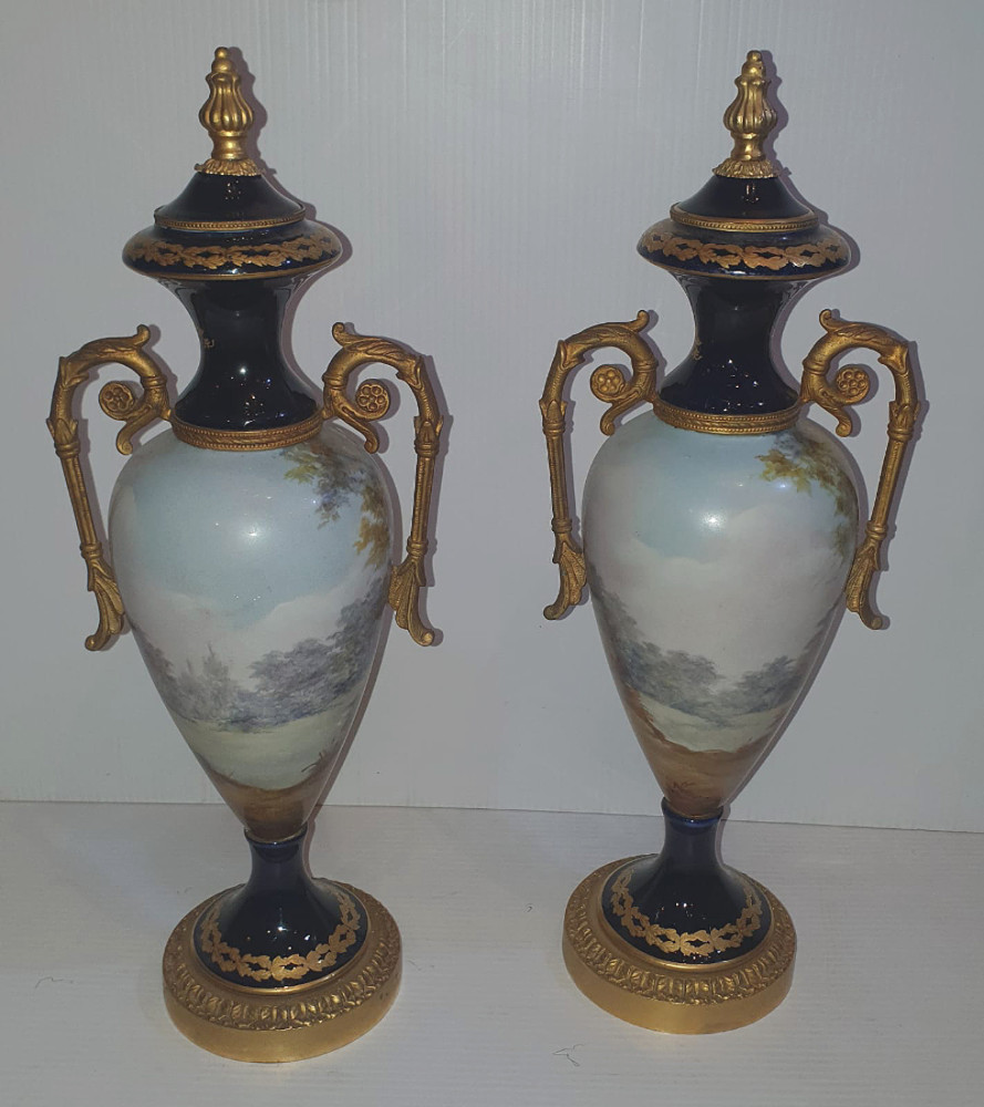 Pair of Hand Painted Early 20th Century French Porcelain Urns with Ormolu Mounts