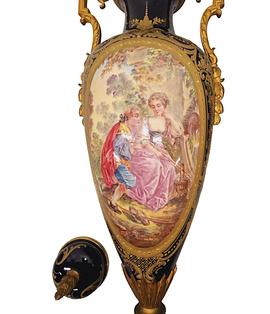 A Very Rare Pair of 19th Century French Hand Painted Sevres Style Urns with Ormolu Mounts