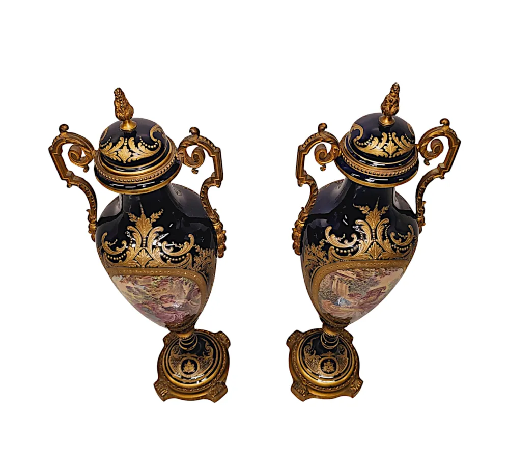 A Very Rare Pair of 19th Century French Hand Painted Sevres Style Urns with Ormolu Mounts